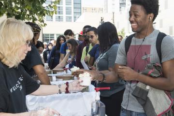 A student receives his ice cream with a smile.