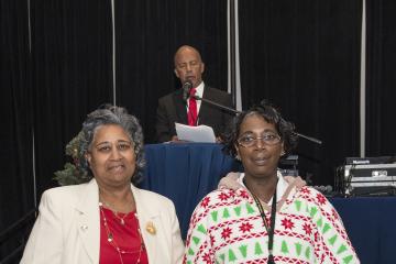 Cathy Redd and Carol Clark pose for the camera with their gifts for 40 years of service