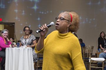 An attendee sings karaoke