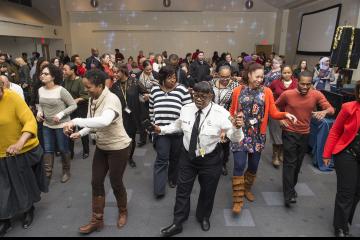 Attendees line dance