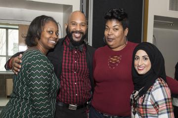 Four attendees pose for the camera