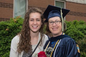 A graduate celebrates with her daughter.