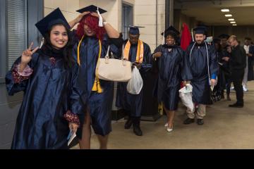 Graduates line up before the march into the arena.