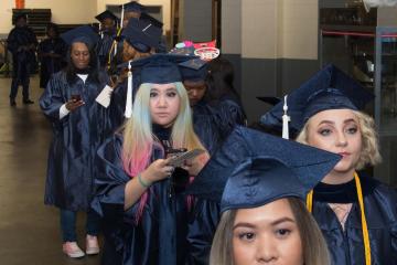 Graduates line up before the march into the arena.