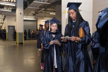 Graduates line up before the march into the arena.