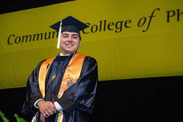 A graduate smiles for the camera.