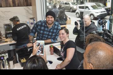 Chris Long and a customer pose for cameras.