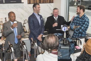 Mayor Kenney speaks as Dr. Generals enjoys his Saxbys coffee.