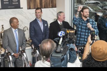 Chris Long raises a fist and says, "Go Eagles!"