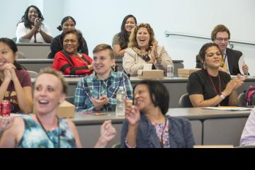 The audience members react and sing along with MC Amy Birge's rendition of "I Will Survive."