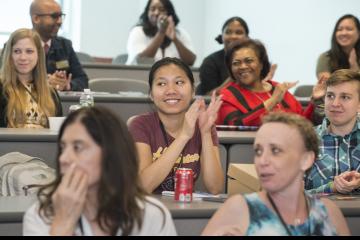 The audience members react and sing along with MC Amy Birge's rendition of "I Will Survive."