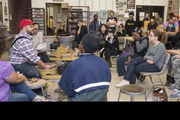 Roberto Lugo describes his technique as he spins a pot on the wheel