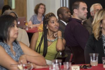 The crowd listens to MC Nestor Torres.