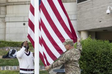 The Stars and Stripes are raised for the ceremony.