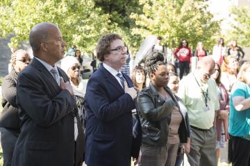 President Dr. Generals, Vice President Sam Hirsh, and the crowd stand for the National Anthem.