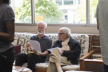 Two faculty members chat before the Teaching Slam.