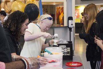 Welcome Week Staff serve students water ice.