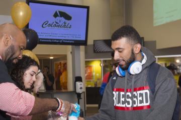 A student receives his free water ice.