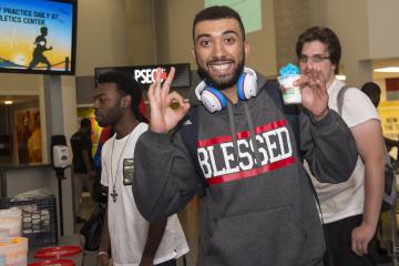 A student poses with his water ice and a smile.