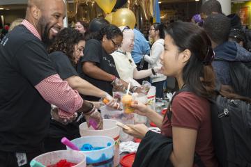 Welcome Week Staff serve students water ice.