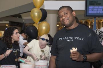 A Welcome Week staff member poses with his water ice.