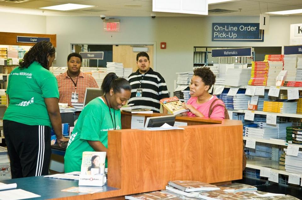 People buying books in College bookstore