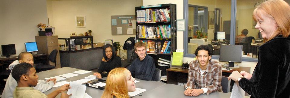 Students around table smiling
