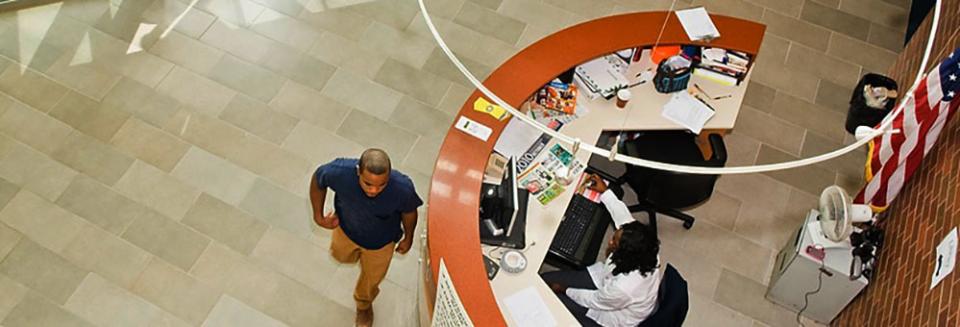 Student Walking Past Desk